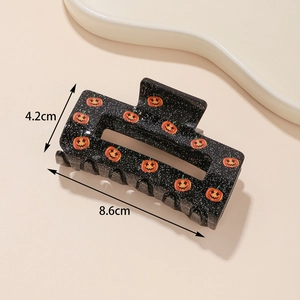 Detail showing 8.6cm Halloween pumpkin hair claw with sparkling black finish