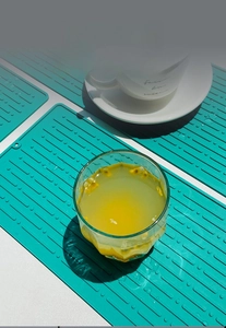 Macro detail of teal silicone drying mat showing raised ridges and hanging hole feature