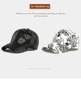 Detail of black and white baseball caps with intricate floral prints and curved brims