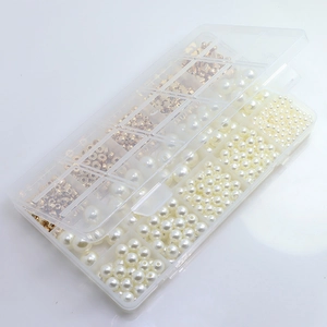Detail view of transparent storage box with assorted ABS pearls and golden spacer beads