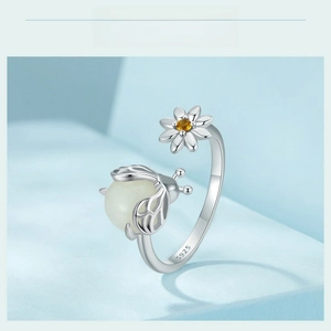 Macro detail of S925 sterling silver ring showing honeybee and daisy with S925 hallmark
