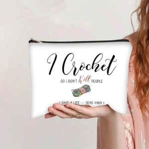 Close-up of white canvas crochet bag with black typography and yarn illustration