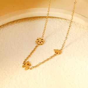 Gold stainless steel necklace with Christmas tree, reindeer, and snowflake pendants