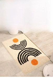 Detail of Nordic minimalist bathroom mat with orange geometric patterns and thick plush texture