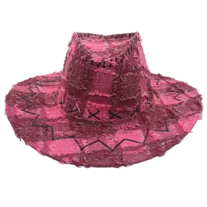 Detail of pink and burgundy distressed western cowboy hat with frayed edges and cross stitches