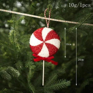 Detail of red and white spiral lollipop ornament with bow on green Christmas tree branch