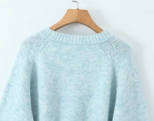 Detailed close-up of light blue mohair knit sweater back neck and shoulder stitching