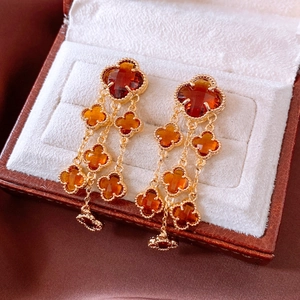 Detail of 18k gold plated glass flower tassel earrings with vintage clover design