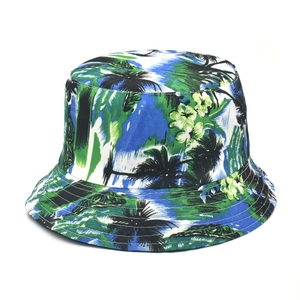 Close-up of tropical palm leaf and floral patterns on high-quality fabric sun hat