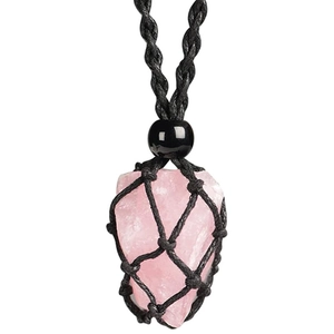Detail view of natural rose quartz raw stone wrapped in black woven mesh cord