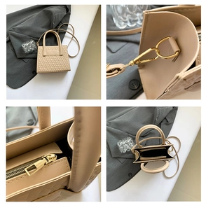 Detail view of beige quilted handbag showing gold hardware, zipper and interior structure