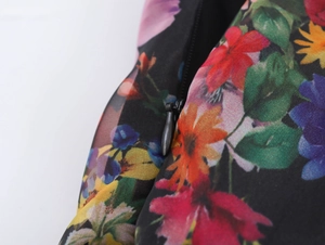 Detailed macro view of the invisible black zipper on floral print organza puffy dress