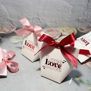 Romantic white wedding candy boxes with Love lettering and red pink ribbon bows