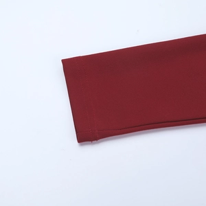 Macro shot of double-needle stitching on the dark red long sleeve cuff fabric