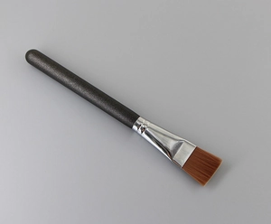 Flat top foundation brush with black glitter handle and soft brown synthetic bristles