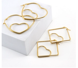 Detailed view of 18K gold plated heart and square geometric earrings on white background