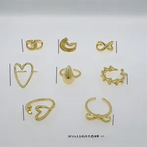 Detailed view of eight 18K gold plated ring designs with heart and infinity motifs