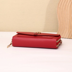 Detail of red faux leather phone wallet with double gold zippers and embossed logo