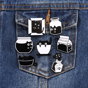 Set of 7 cute black and white cat alloy badges pinned on denim jacket pocket