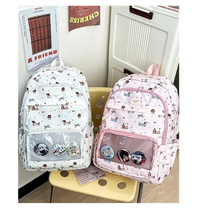 Detail of pink and white school backpacks with clear front pockets and cute dog prints