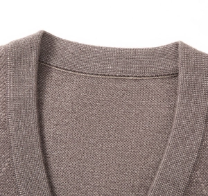 Detail shot of the V-neck stitching and fine knit texture on this brown knit vest cardigan