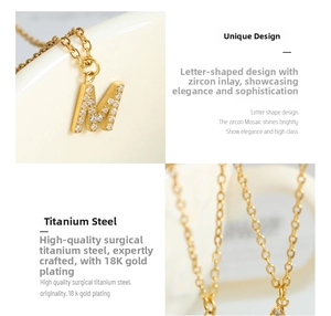 Detailed macro view of 18K gold plated letter M pendant with clear zircon inlay