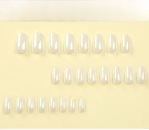 Detail view of 24pcs white laser press-on nails with glossy finish on a smooth background
