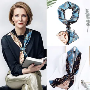 Detail of silk scarf featuring elegant chain patterns in blue, black, and beige panels