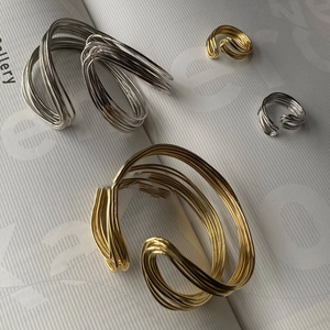 Twisted layered metal cuff bracelet and ring set in polished gold and silver finish
