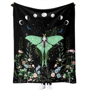 Detail of soft flannel blanket featuring green lunar moth, moon phases and floral print