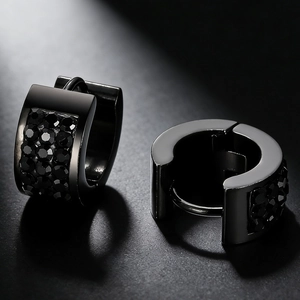 Macro shot of black paved rhinestones on gothic style stainless steel hoop earrings
