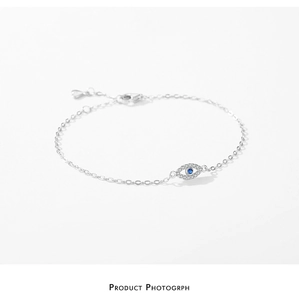 Detailed close-up of S925 silver evil eye bracelet with blue zircon and lobster clasp