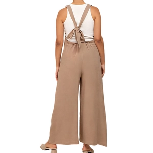 Detail of maternity wide-leg wool pants with a cross-back bow tie and high waist design