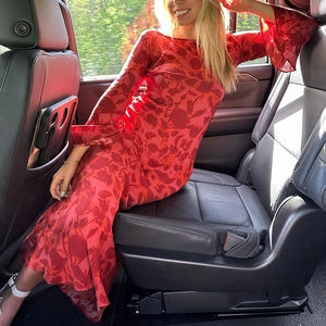 Detailed close-up of red floral print maxi dress featuring long sleeves and sheer chiffon fabric
