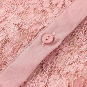 Pink lace polo shirt for women featuring a button-down collar and detailed floral texture