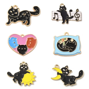 Detail of six black cat enamel charms with colorful celestial patterns for DIY jewelry