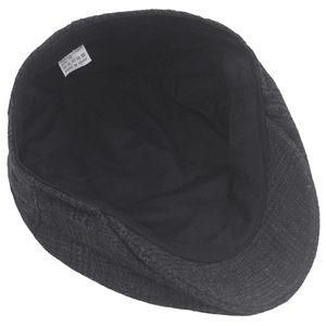 Detail view of dark grey herringbone newsboy cap interior lining and size 58 label