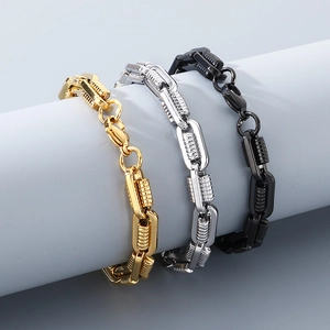 Detail view of steel link chains in gold, silver, and black finish on a grey stand