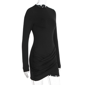 Detail view of the elegant ruched side texture on this black long sleeve slim mini dress