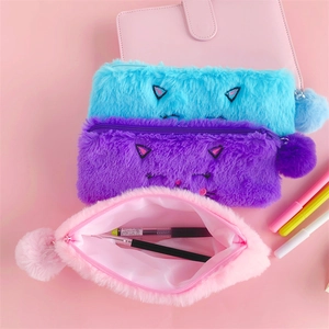 Three colorful plush cat pencil cases in blue, purple and pink with fluffy pompom zippers