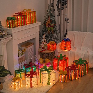 Three-piece glowing Christmas gift box set with LED lights and festive bows for decor