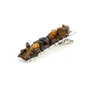 Detailed view of handmade alligator hair clip with tiger eye natural stone and silver wire