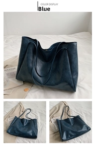 Detailed view of the blue oversized tote bag showing its vintage cracked leather texture