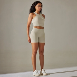 Close-up of seamless knit ribbed sports vest and high waist yoga shorts in light beige