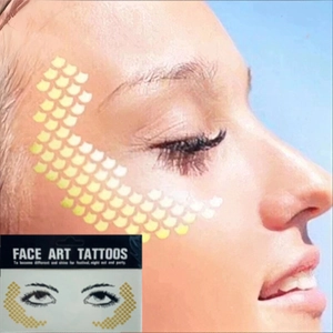 Metallic gold freckle star face tattoos for festival parties and makeup art