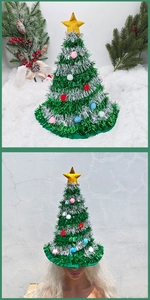 Detail view of a green tinsel Christmas tree hat with colorful pom-poms and gold star topper