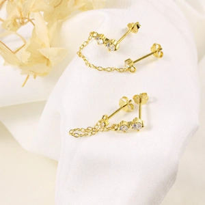 Close-up of S925 silver gold-plated chain stud earrings with sparkling cubic zirconia