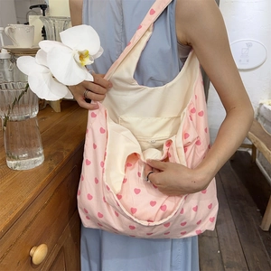 Close-up of pink canvas tote bag featuring red heart patterns and large capacity