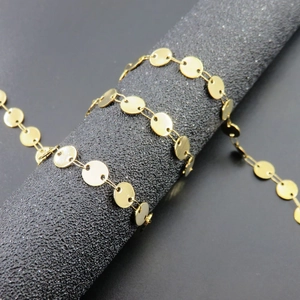 Macro detail of 18K gold plated stainless steel disc chain with polished round links