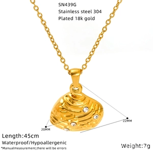 Detailed close-up of a 18k gold plated starfish pendant on a stainless steel necklace